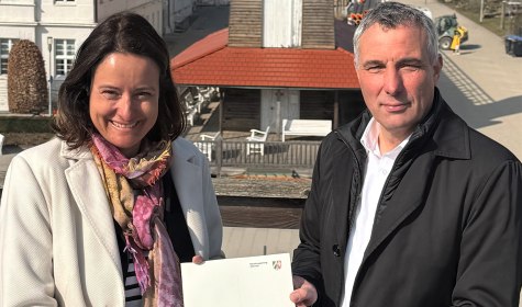 Neues Großprojekt in der Kurstadt: Das Uhrenturmgradierwerk (Hintergrund) wird zum reinigenden „Opfergradierwerk. Regierungspräsidentin Anna Katharina Bölling (links) übergab den Förderbescheid an Bürgermeister Dirk Tolkemitt., © Stadt Bad Salzufen